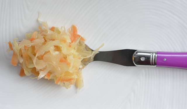 A forkful of sweet garlic sauerkraut. | MakeSauerkraut.com