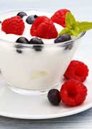 A small cup of yogurt with blueberries and raspberries. | MakeSauerkraut.com