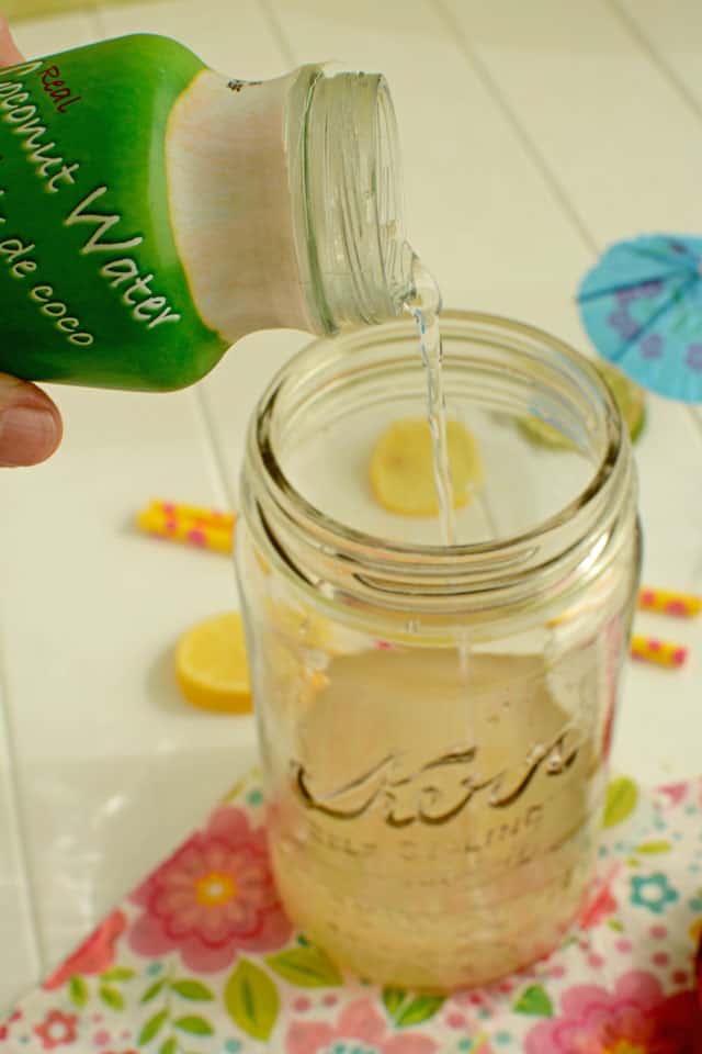 Adding coconut water to a jar with the kefir grains. | MakeSauerkraut.com