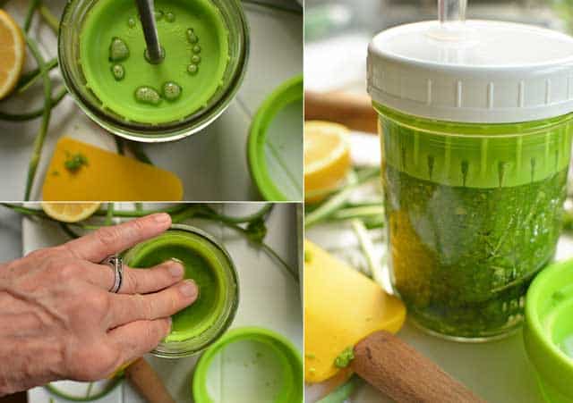 Making garlic scape paste using the Ultimate Pickle Jar system. | makesauerkraut.com