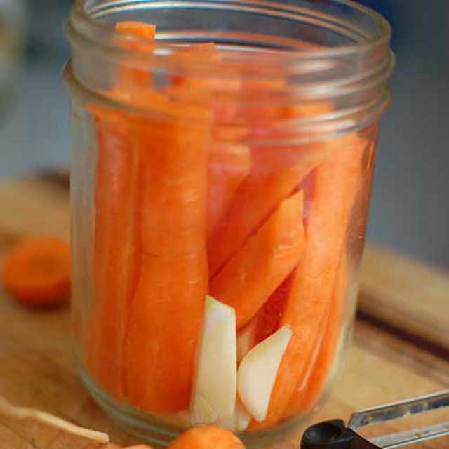 Carrot sticks packed into the jar. | MakeSauerkraut.com