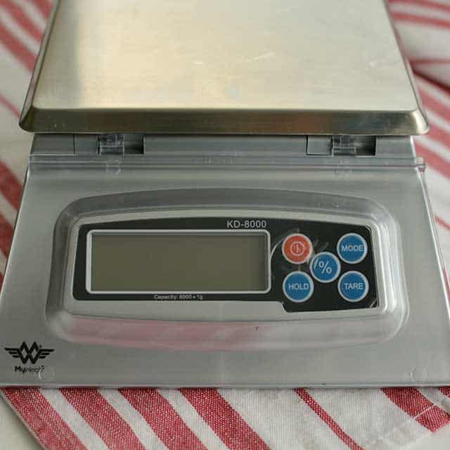 Front view of MyWeigh KD-8000 digital scale on striped red and white cloth. | MakeSauerkraut.com