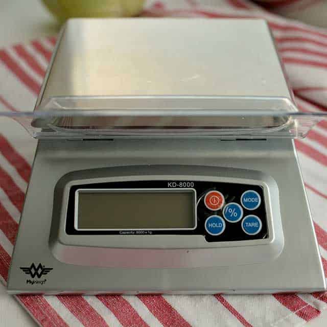 Front view of MyWeigh KD-8000 digital scale on striped red and white cloth. | MakeSauerkraut.com