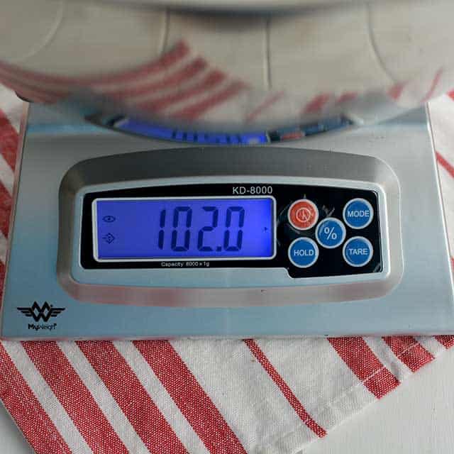 Front view of MyWeigh KD-8000 digital scale and the screen showing "102.0". | MakeSauerkraut.com