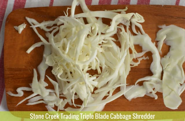 Piles of sliced cabbages on top of chopping using a Stone Creek Trading Triple Blade Cabbage Shredder. | MakeSauerkraut.com