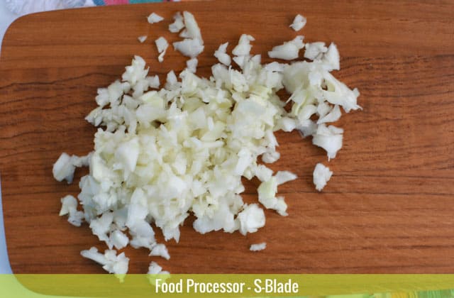 Sliced cabbages on top of a wooden chopping board sliced using the S-blade of a food processor. | MakeSauerkraut.com