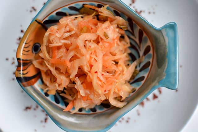 Top view of Kimchi Style Sauerkraut Recipe in a fish-shaped bowl. | MakeSauerkraut.com