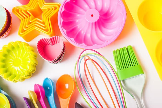 Colorful silicone kitchen tools like spoons, cupcake molds, and brush. | MakeSauerkraut.com