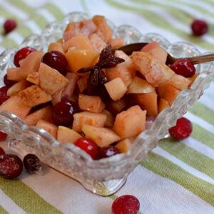 A cut-glass square serving dish containing Raw Cranberry Apple Chutney. | MakeSauerkraut.com