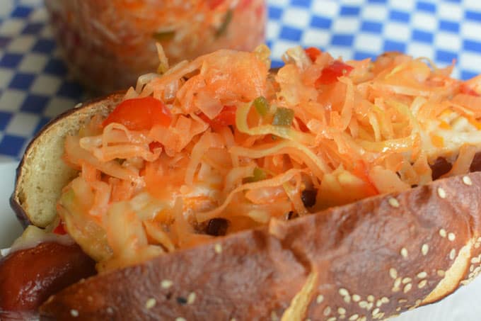 A hotdog in a bun topped with Baseball Park Sauerkraut. | MakeSauerkraut.com