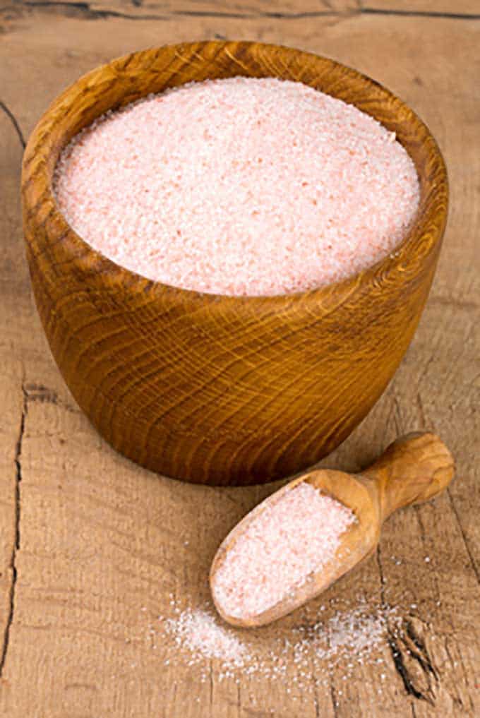 Himalayan pink salt inside wooden bowl and scooper. | MakeSauerkraut.com