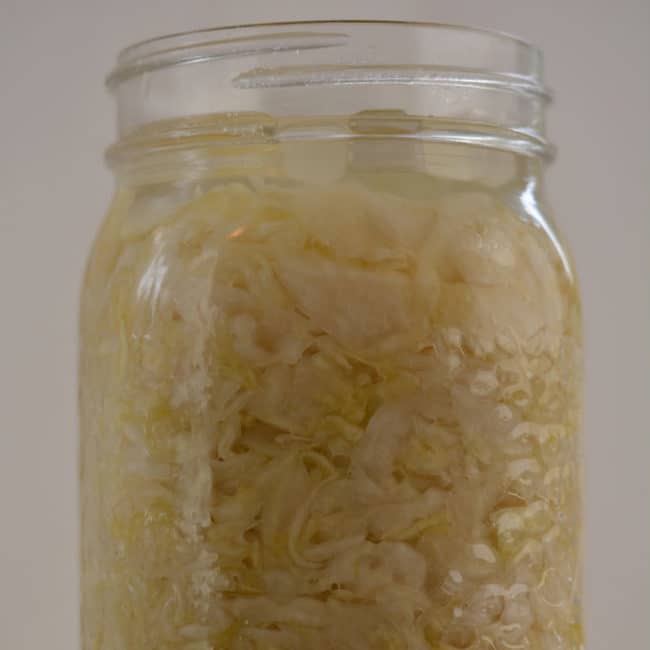 Front view of a plain sauerkraut using the Easy Weight fermentation weight at day 7. | MakeSauerkraut.com