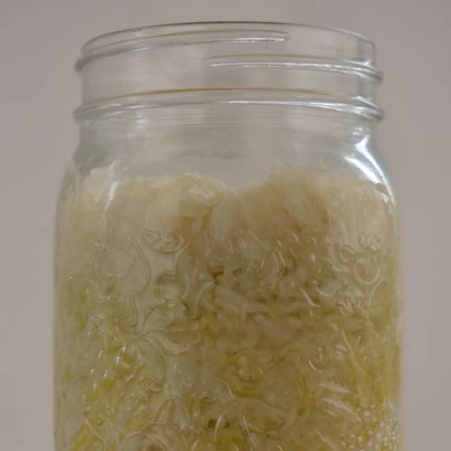 Front view view of a plain sauerkraut without using any fermentation weight at day 7. | MakeSauerkraut.com