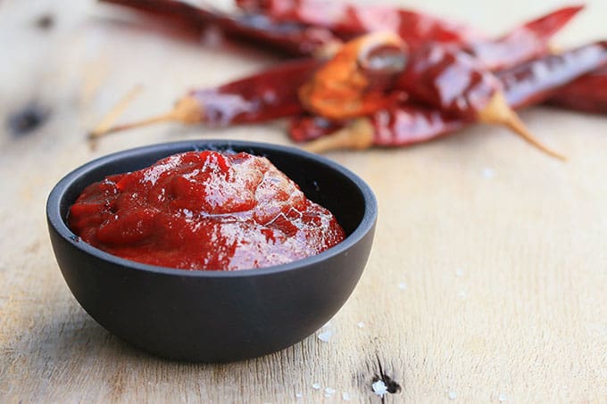 Gochujang or red pepper paste in small black bowl. | MakeSauerkraut.com