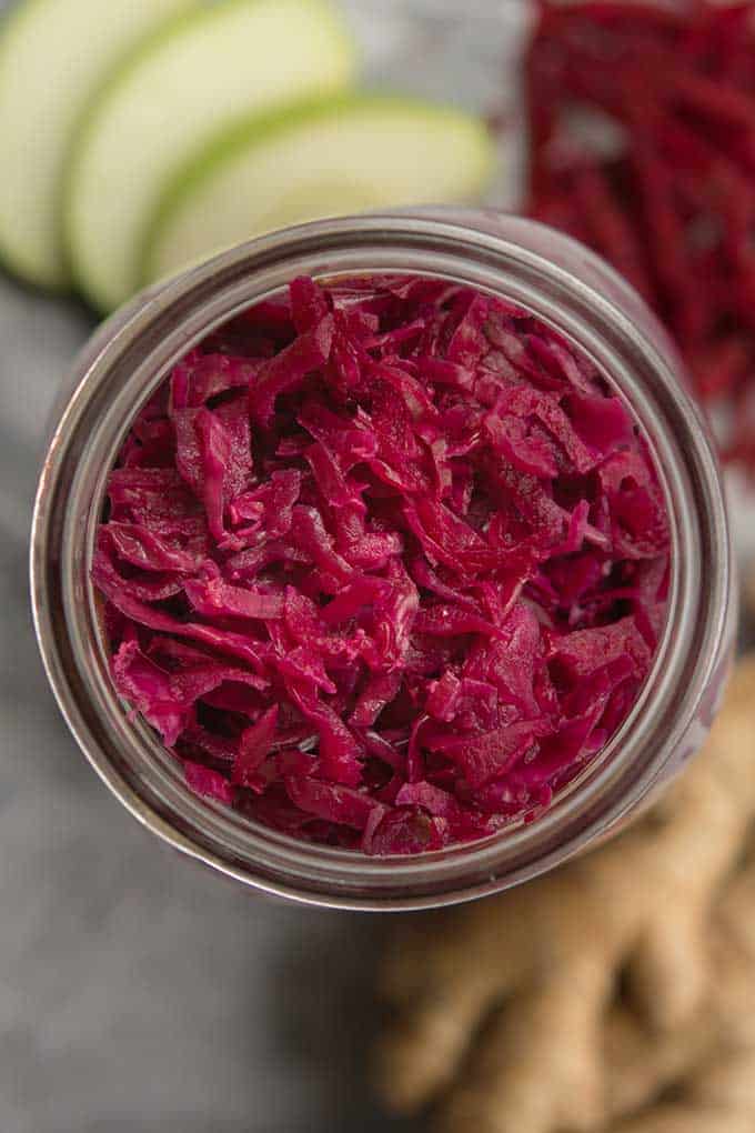 Top view of an opened jar of Red cabbage sauerkraut with beets and apple. | MakeSauerkraut.com