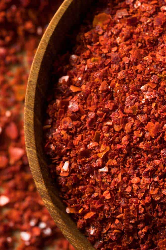 Close up of Korean red pepper flakes in a wooden bowl. | MakeSauerkraut.com