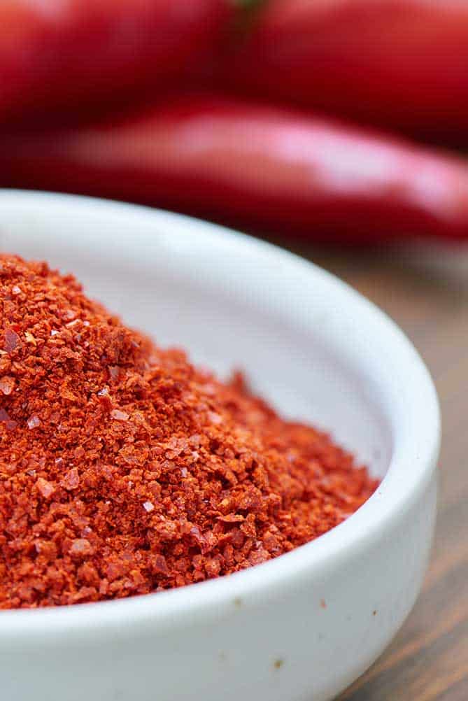 Close up of Korean red pepper flakes in a white bowl. | MakeSauerkraut.com