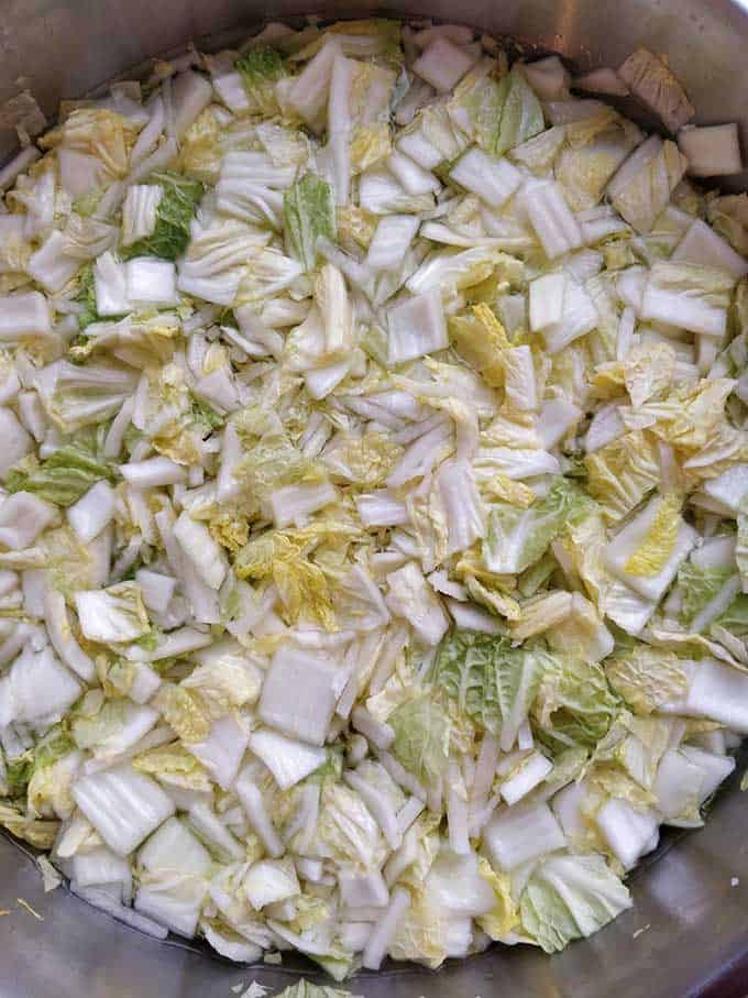 Napa cabbage cut into squares and left to soak in a salty brine overnight. | MakeSauerkraut.com