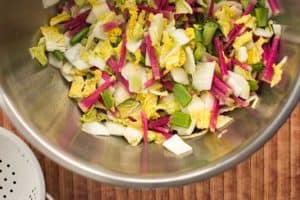 Making traditional square-cut kimchi (Mak Kimchi). Brine cabbage mixed with radishes and green onions ready for red pepper paste. | Makesauerkraut.com