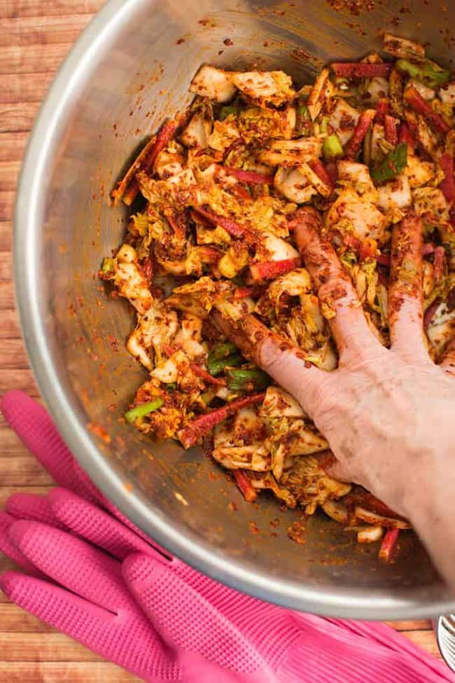 Making traditional square-cut kimchi (Mak Kimchi). Mixing cabbage and red pepper seasoning paste. | Makesauerkraut.com