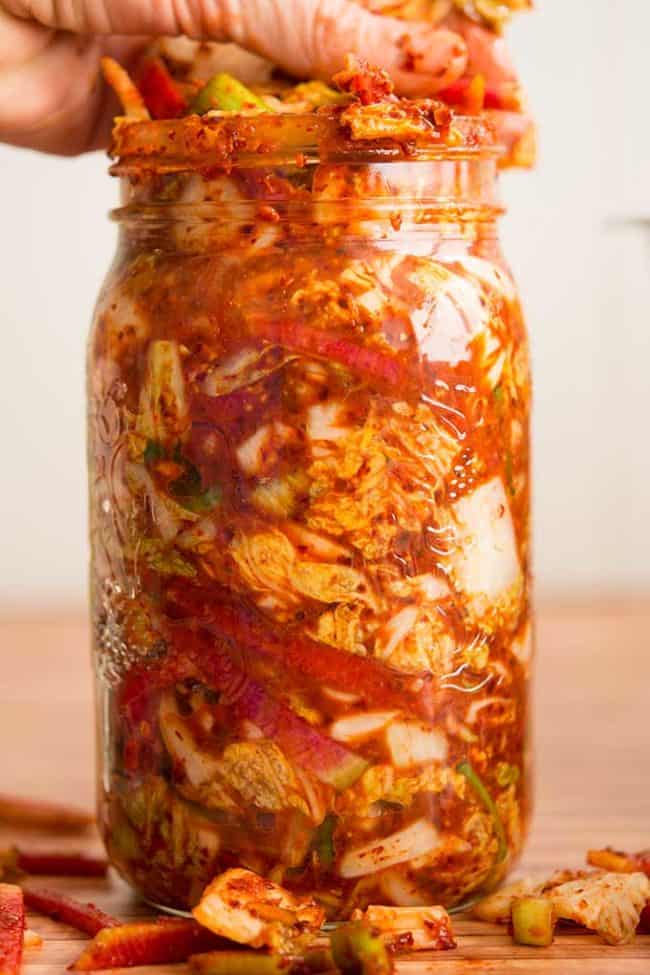 Making traditional square-cut kimchi (Mak Kimchi). Packing kimchi into jar for fermentation. | Makesauerkraut.com