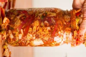 Making traditional square-cut kimchi (Mak Kimchi). Packing kimchi into jar for fermentation. | Makesauerkraut.com