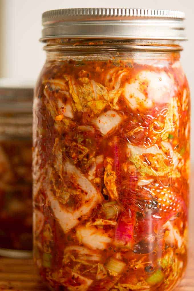 Front view of jar of kimchi ready for fermentation. | MakeSauerkraut.com