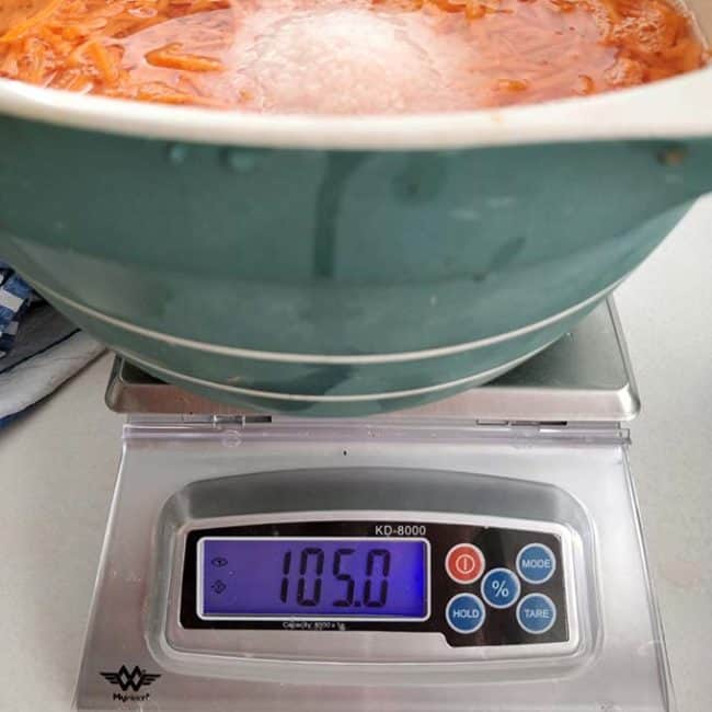 Front view of the MyWeigh KD8000 Digital Scale with the monitor showing "105.0" and partial view of a large bowl. | MakeSauerkraut.com