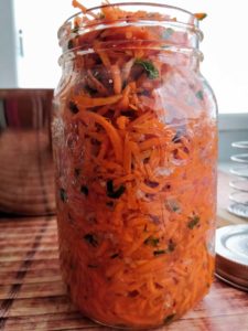 Carrot Kimchi packed into jar. | MakeSauerkraut.com