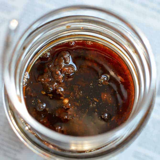 Top view of a PickleHelix used in a jar of fermenting Raisin Chutney. | MakeSauerkraut.com