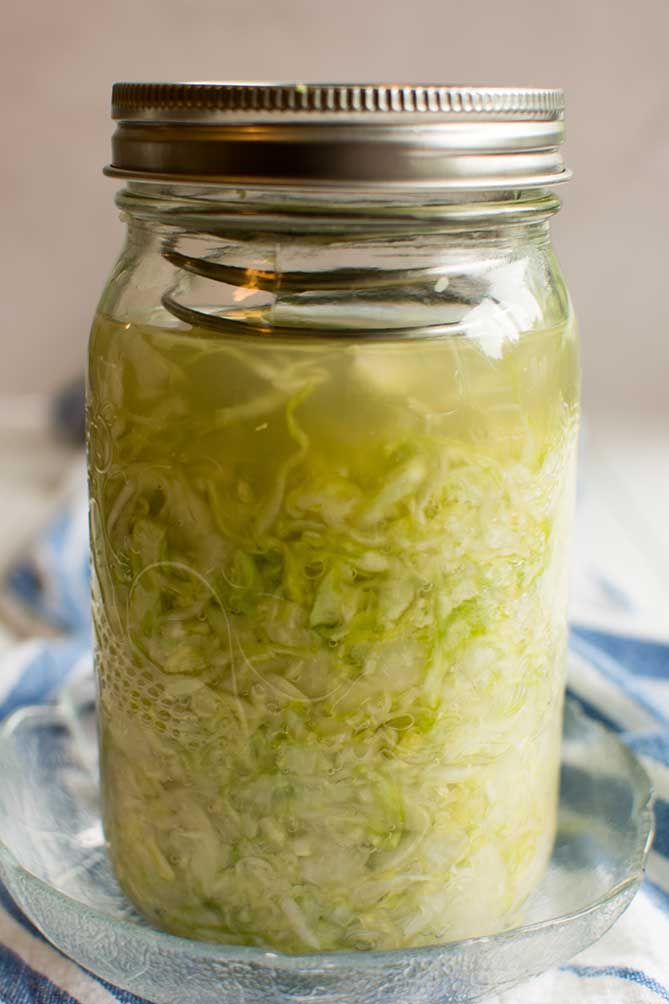 Front view of the  PickleHelix used in a jar of fermenting sauerkraut. | MakeSauerkraut.com