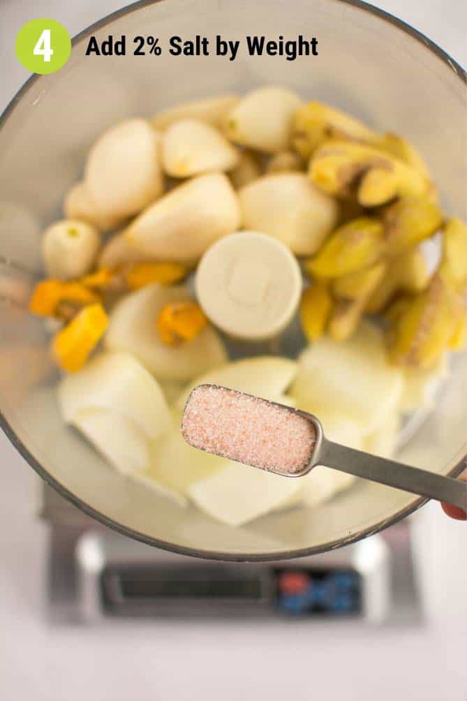 Top view of  ingredients inside a mixing bowl over a MyWeigh KD-8000 and spoonful of salt about to be added. | Makesauerkraut.com