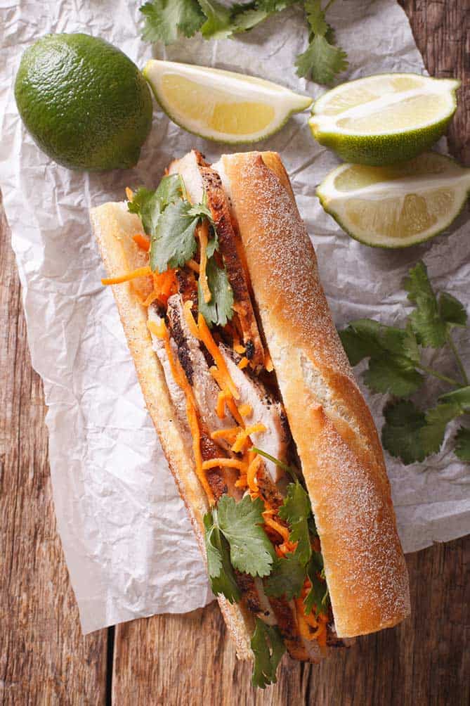 Sandwich in baguette with carrots, cilantro, and lime. | MakeSauerkraut.com