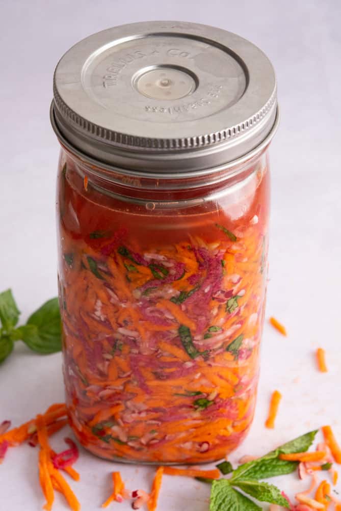 Finished packed jar of ingredients for Fermented Radish and Carrots Slaw. | MakeSauerkraut.com
