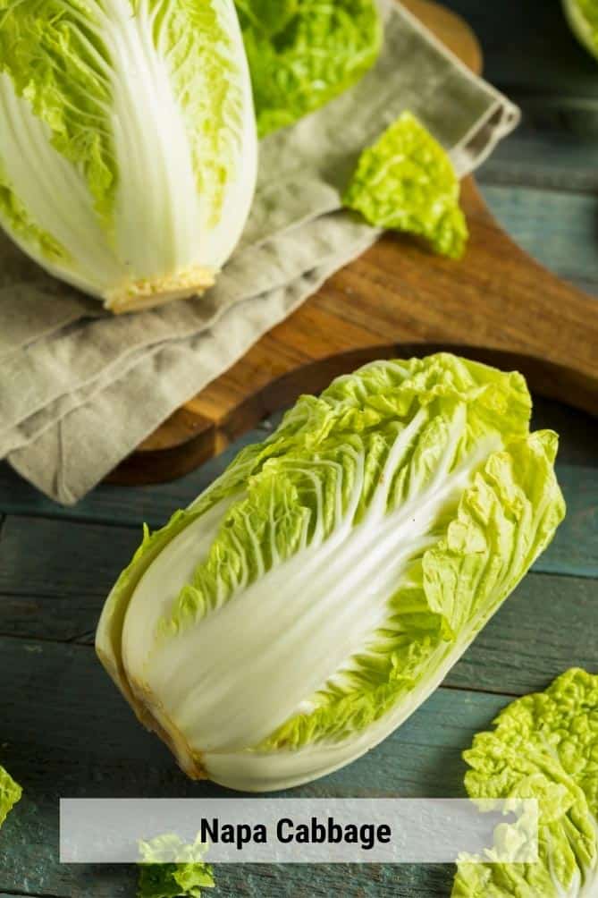 Heads of Napa cabbage on cloth napkin and cutting board. | MakeSauerkraut.com