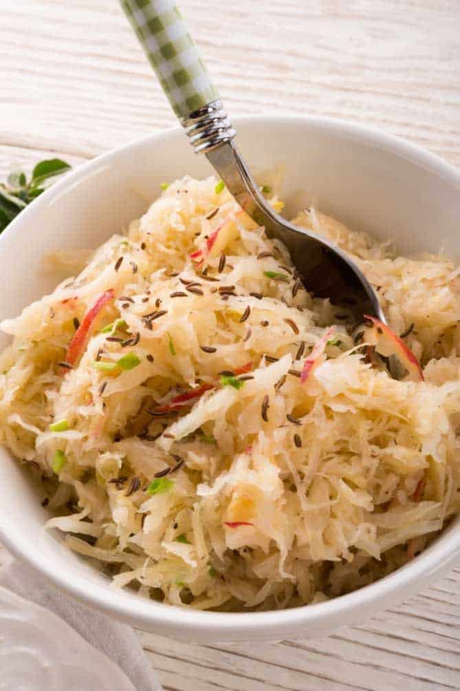Sauerkraut with caraway seeds in a white bowl. | MakeSauerkraut.com