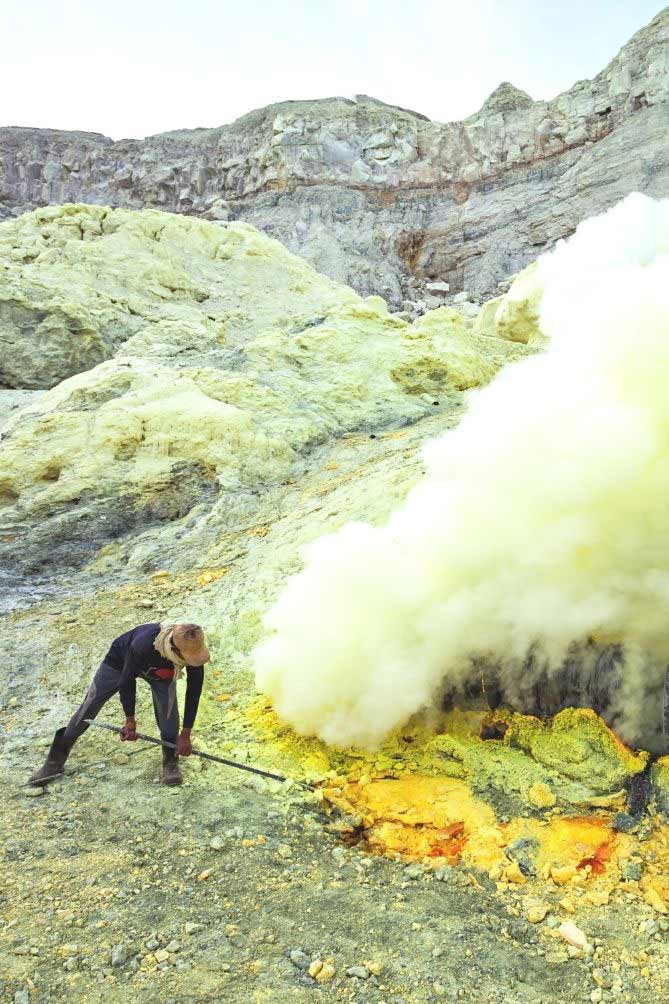 Barren, stony mountain and a man with long metal tool picking through the ground with hydrogen sulfide gas emitting from the ground. | MakeSauerkraut.com