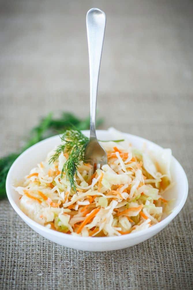 Fork in bowl of probiotic-rich sauerkraut. | MakeSauerkraut.com