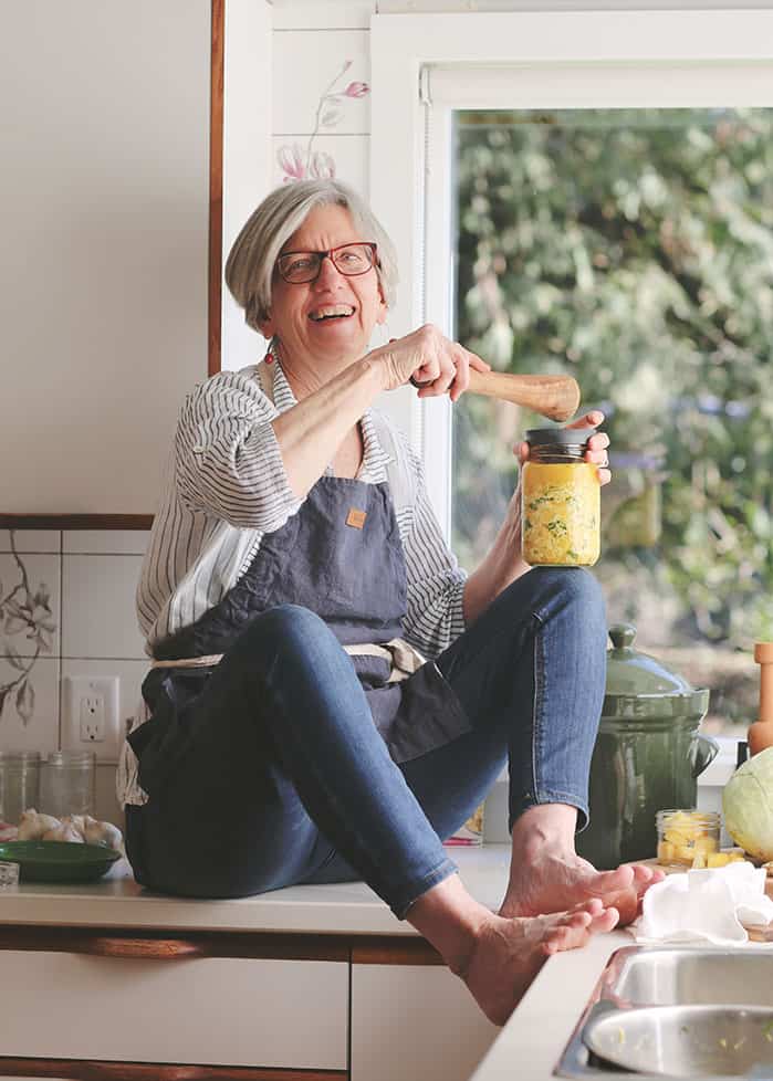 Holly Howe holding a jar of sauerkraut. | MakeSauerkraut.com