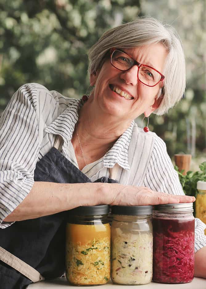 Holly-Howe-sauerkraut-jars Holly Howe with three jars of sauerkraut. | MakeSauerkraut.com