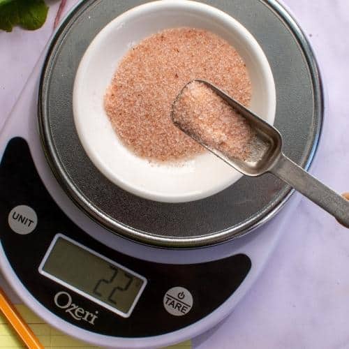 Small white bowl on scale to measure salt. | MakeSauerkraut.com