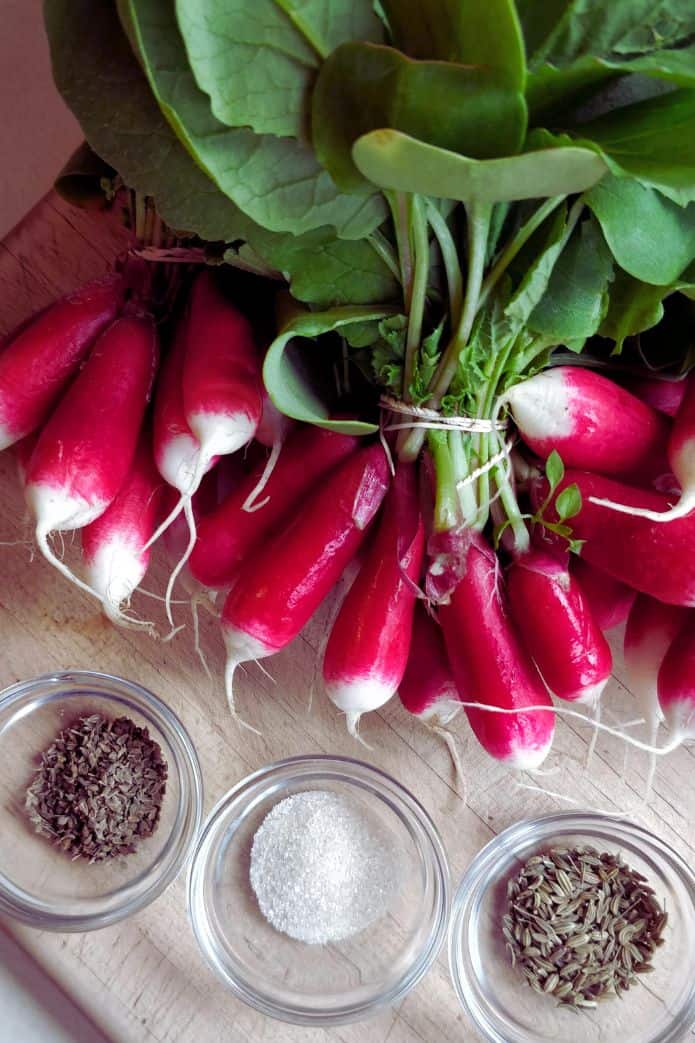 Bunches of fresh radishes with seasonings. | MakeSauerkraut.com