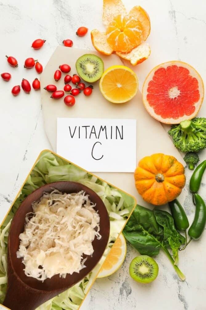 Various fruits and vegetables high in vitamin c on a tabletop. | MakeSauerkraut.com