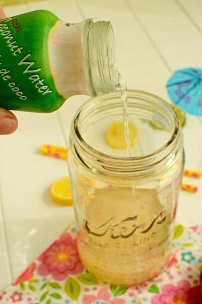 Fermented Coconut Water poruing into a jar. | makesauerkraut.com