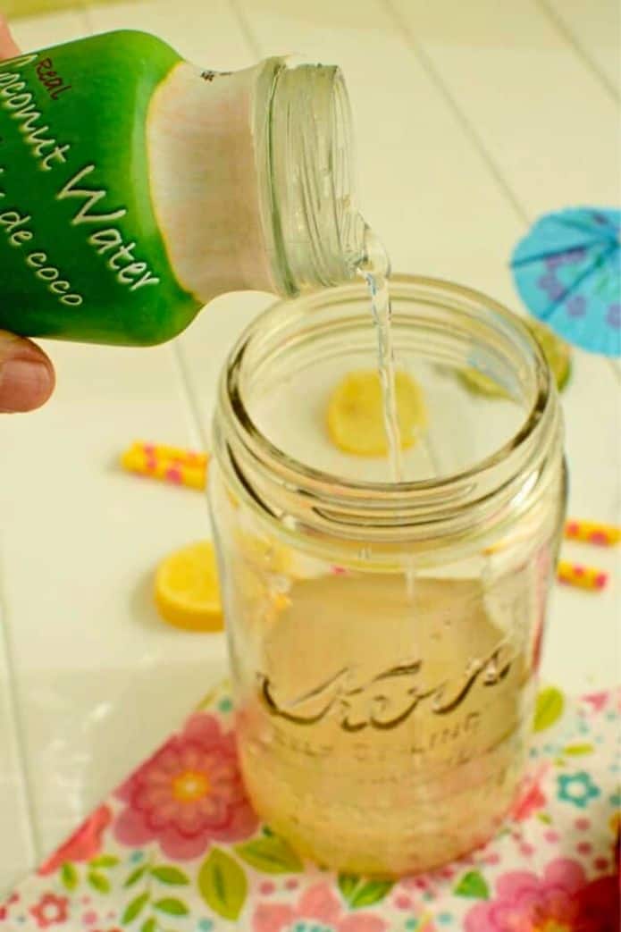 fermented coconut water Fermented Coconut Water poruing into a jar. | makesauerkraut.com