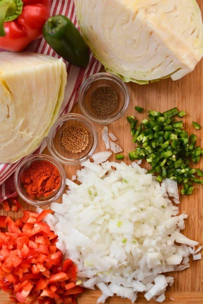 sauerkraut recipe Chopped vegetables and spices on a wooden board. | makesauerkraut.com