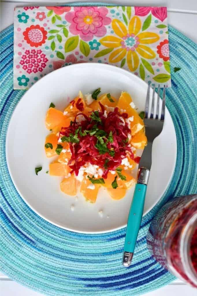 Beet sauerkraut and orange salad on a plate. | makesauerkraut.com