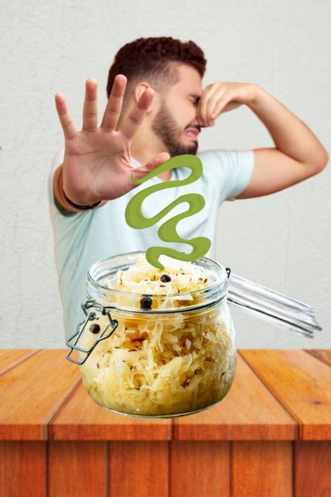 Man with plugged nose next to serving of sauerkraut. | MakeSauerkraut.com
